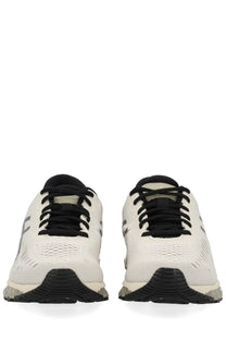 Asics unisex gel quantum sneaker in white and black with breathable mesh upper and textured rubber sole