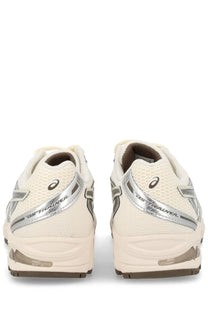 Cream-colored asics unisex sneaker gel ds trainer with silver metallic accents and a breathable mesh upper