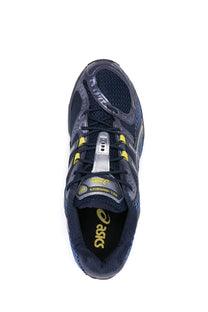 Dark blue asics gel nimbus 13 running shoe with yellow accents and silver metallic lace lock for unisex use