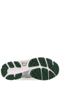 Back view of asics unisex sneaker gel nyc with white and green rubber sole and silver midsole featuring the logo
