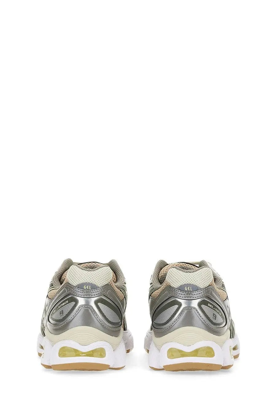 Asics women’s gel nimbus sneaker in silver and beige with a translucent yellow air unit in the sole