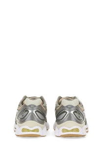 Asics women’s gel nimbus sneaker in silver and beige with a translucent yellow air unit in the sole