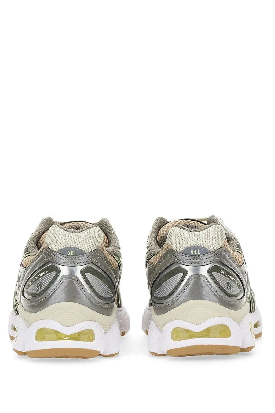 Asics women’s gel nimbus sneaker in silver and beige with translucent yellow air cushioning unit for running