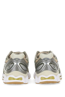 Asics women’s gel nimbus sneaker in silver and beige with translucent yellow air cushioning unit for running