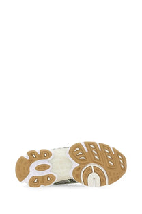 White and tan rubber sole with sculpted oval cutouts on asics women’s gel nimbus silver sneaker