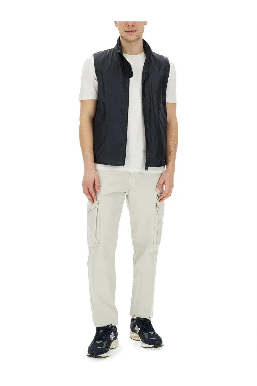 Black nylon sleeveless vest with stand-up collar and front zipper paired with aspesi men’s beige cotton pants