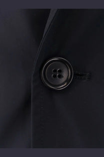 Black round button with four holes and metallic sheen on aspesi men’s paperino stretch nylon blue blazer