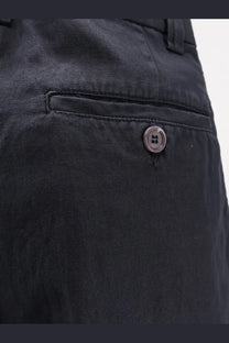 Back view of aspesi women’s blue cotton and linen shorts with dark gray textured weave and single button back pocket closure