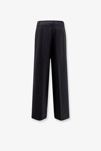 Black wide-leg wool blend trousers by Aspesi with a tailored fit and subtle back pleats shown from the back side