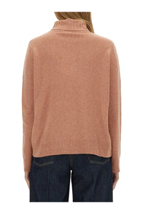 A soft peach-colored long-sleeved wool jersey turtleneck sweater with ribbed hem and cuffs from ASPESI women’s collection