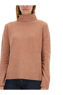 A soft peach-colored turtleneck sweater with ribbed knit texture and long sleeves in aspesi women’s wool jersey blue collection