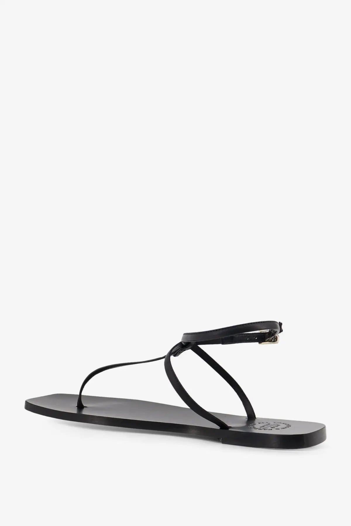 Black leather thong sandal with minimalist design and small metallic buckle on the ankle strap by ATP Atelier