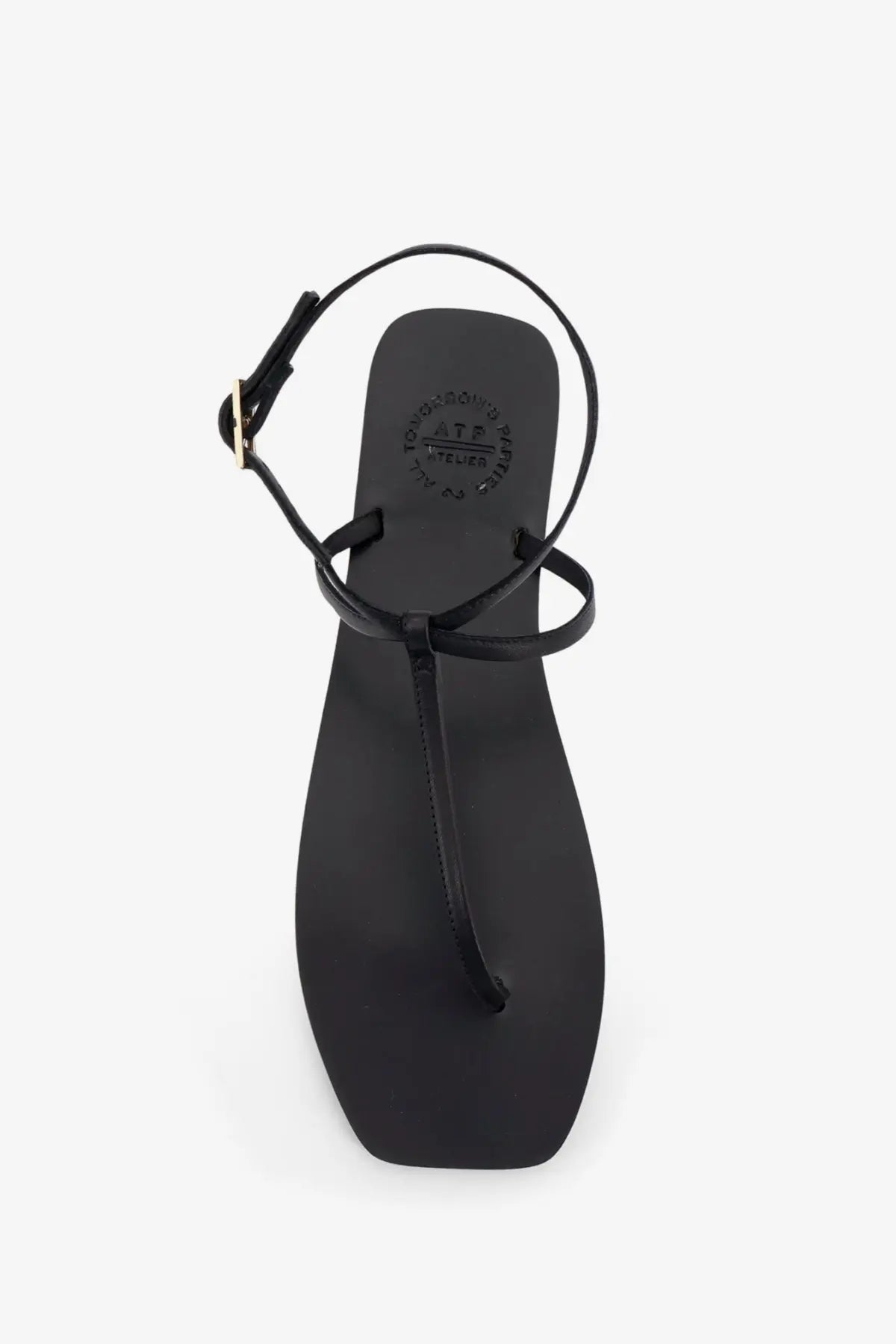 Black leather thong sandals for women with a minimalist design and adjustable ankle strap by ATP Atelier