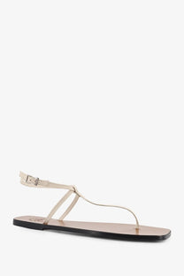Cream-colored leather thong sandal with minimalist design and black rubber sole from ATP Atelier women’s Alassio linen collection