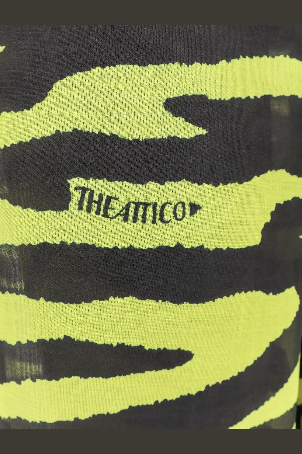 A neon yellow and black zebra-striped scarf with theattico logo embroidered paired with black cotton beachwear trousers