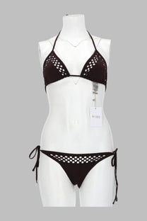 Black crochet bikini set with halter top and side-tie bottoms featuring circular cutouts in lycra by the attico