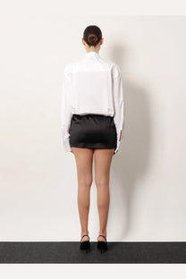 The attico womens black white mini dress black featuring a sleek black satin high waist skirt with subtle side slits