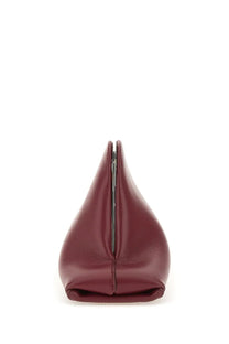 A sleek burgundy leather Attico women’s clutch with minimalist design and central metal clasp for day off use