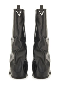 The attico women’s combat boot robin black made of glossy black leather with a silver triangular logo at the top