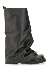 The attico women’s combat boot robin black in black patent leather with a draped asymmetrical design and chunky sole