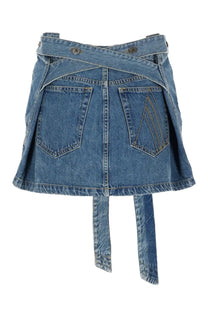 The attico women’s blue denim mini skirt with cross-over waistband and back pockets shown from the back side