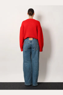 Red ribbed knit sweater with a cropped fit and long sleeves paired with the attico women’s blue jeans