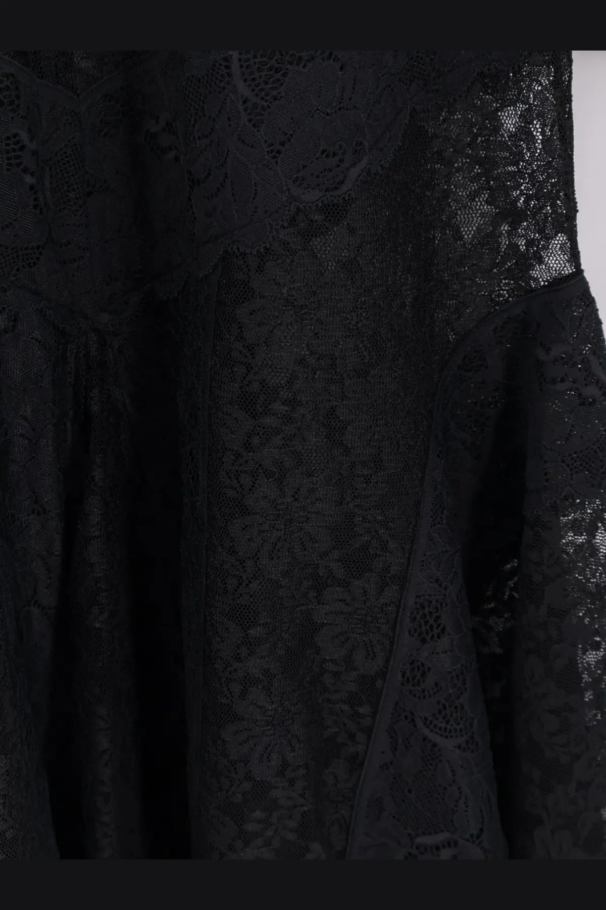 The attico women’s lace dress black featuring intricate floral patterns and flowing sheer fabric