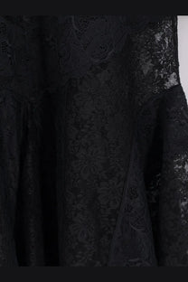 The attico women’s lace dress black featuring intricate floral patterns and flowing sheer fabric