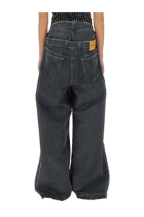 The attico women’s long navy blue grey denim wide-leg pants shown from the back with classic pockets and relaxed fit
