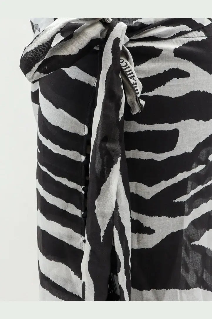 The attico women’s pareo cotton skirt in black with a black and white zebra-print scarf tied at the waist