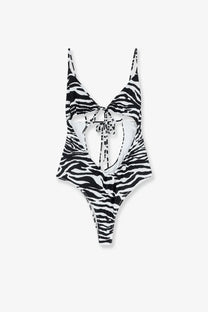 The Attico women’s one piece swimsuit in black and white zebra print with thin straps and tied front detail