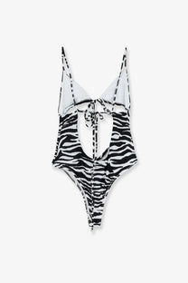 The Attico women’s black one-piece swimsuit with zebra stripes, thin straps, and a back tie detail shown from the back