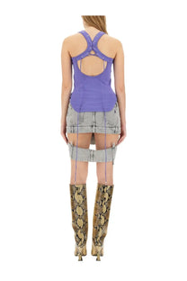 The attico women’s purple crisscross-back tank top styled with a denim skirt and snake-print boots shown from the back