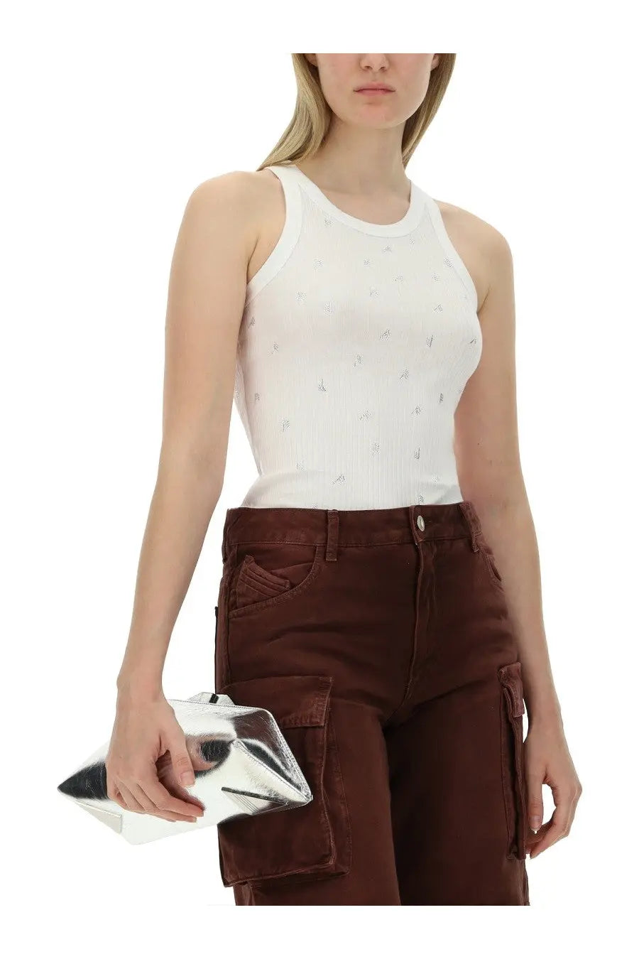 Silver metallic clutch with geometric angular design complementing The Attico women’s tops white collection