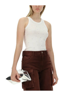 Silver metallic clutch with geometric angular design complementing The Attico women’s tops white collection