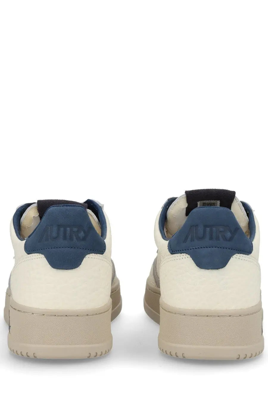 Back view of autry men’s medalist low sneaker in beige cream suede with navy heel tabs and rubber soles