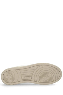 Beige rubber sole of autry men’s medalist low sneaker with circular tread pattern and embossed brand logo