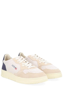 Autry men’s medalist low sneaker in beige and navy suede with white laces and cream rubber sole featuring aurry logo
