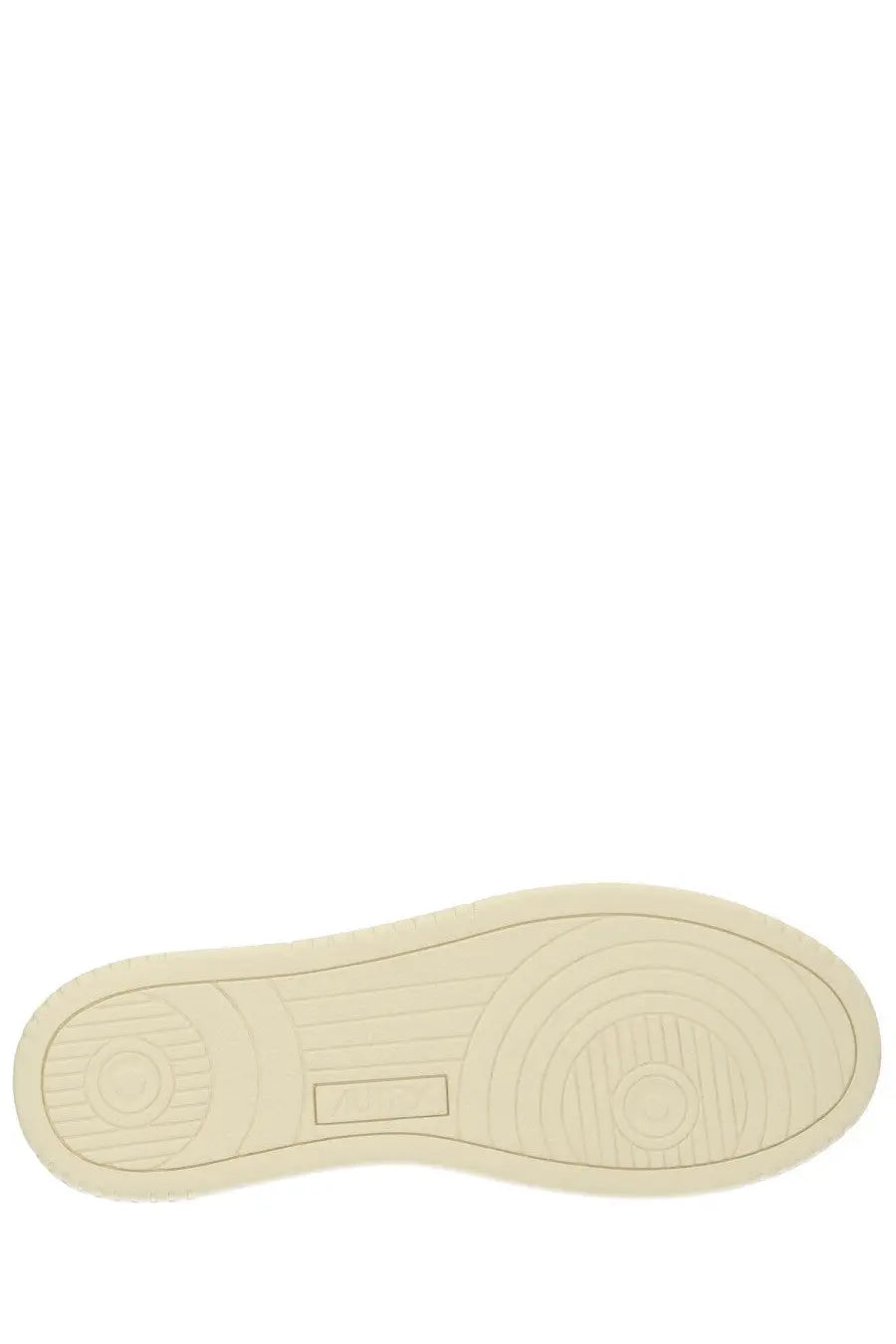Cream-colored rubber sole with concentric circular tread patterns and rectangular embossed patch on autry men’s medalist low sneaker