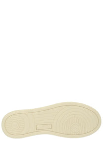 Cream-colored rubber sole with concentric circular tread patterns and rectangular embossed patch on autry men’s medalist low sneaker