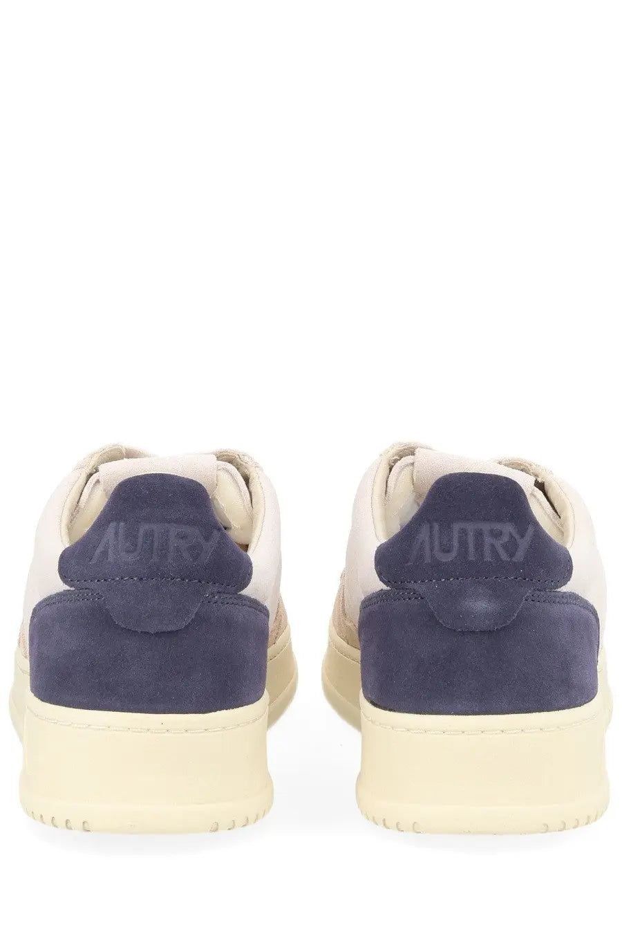 Back view of autry men’s medalist low sneaker in cream with navy blue suede accents and autry logo on the heel