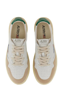 Autry men’s medalist low sneaker white featuring white and beige suede with green heel accents and perforated detailing