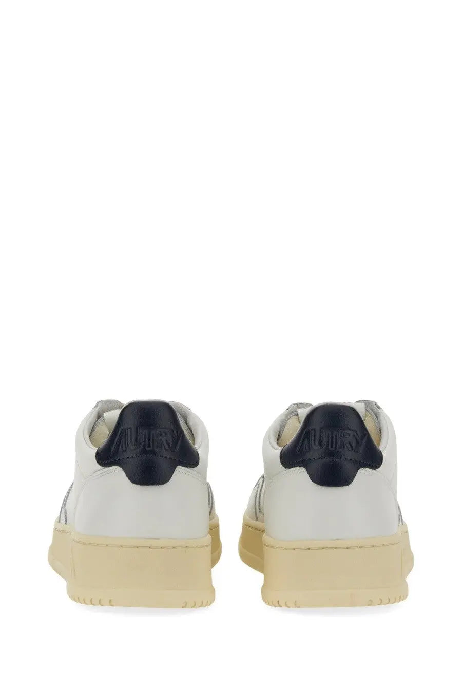 Autry men’s medalist low sneaker white leather with black rubber heel tabs and beige minimalist soles back view