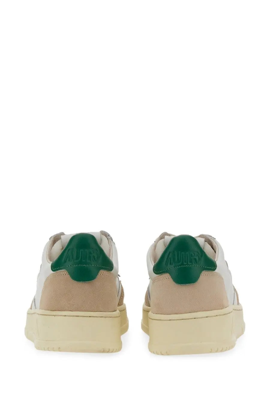 A pair of autry men’s medalist low sneakers in beige and white with green rubber heel tabs and autry logo on the back