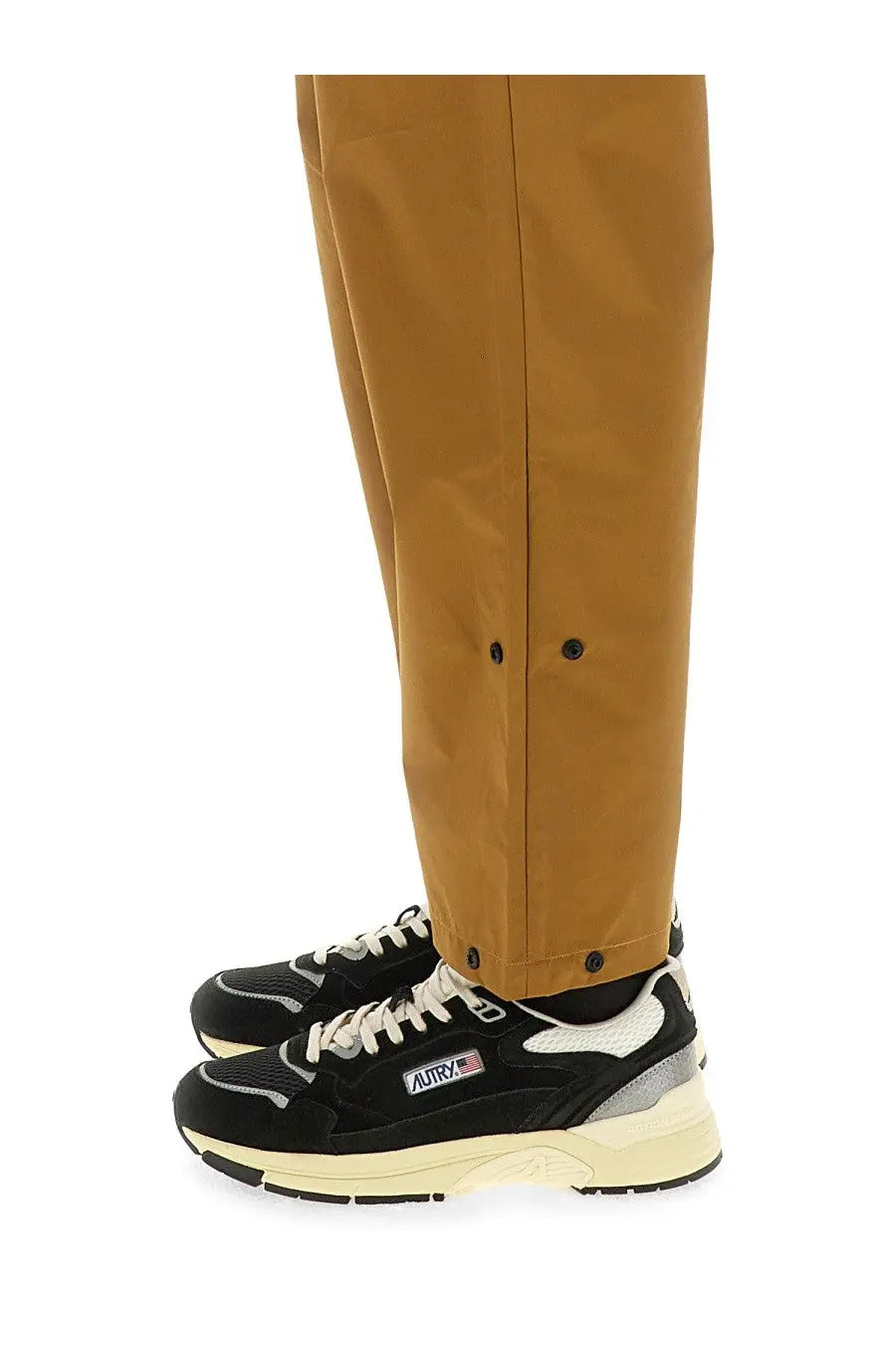 Black and cream aurr sneakers with mesh synthetic overlays and chunky sole paired with autry men’s rain tech nylon pants brown