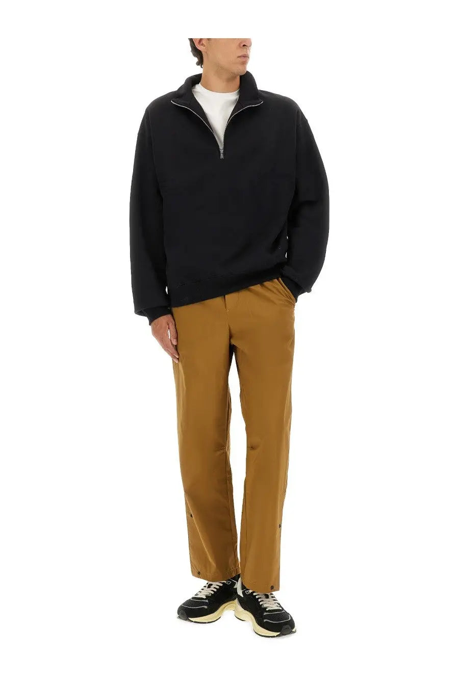 Black half zip fleece pullover with ribbed collar and cuffs paired with autry men’s rain tech nylon pants brown
