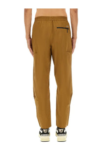 Back view of autry men’s rain tech nylon pants brown with tan elastic waist and subtle black zipper pocket