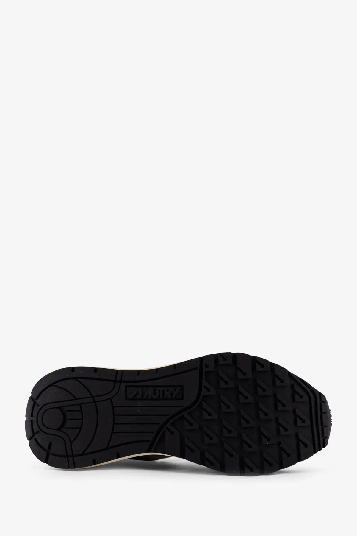 Back side of autry men’s reelwind low suede sneakers white showing black rubber sole with textured tread and aquatry logo