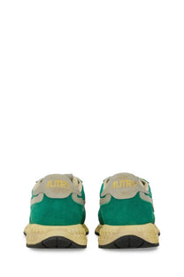 Back view of autry men’s reelwind supervintage sneaker green in green and beige suede with textured yellow sole and gold branding