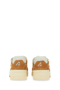 Back view of autry men’s sneaker clc orange tan suede sneakers with white rubber soles and white logo on heel
